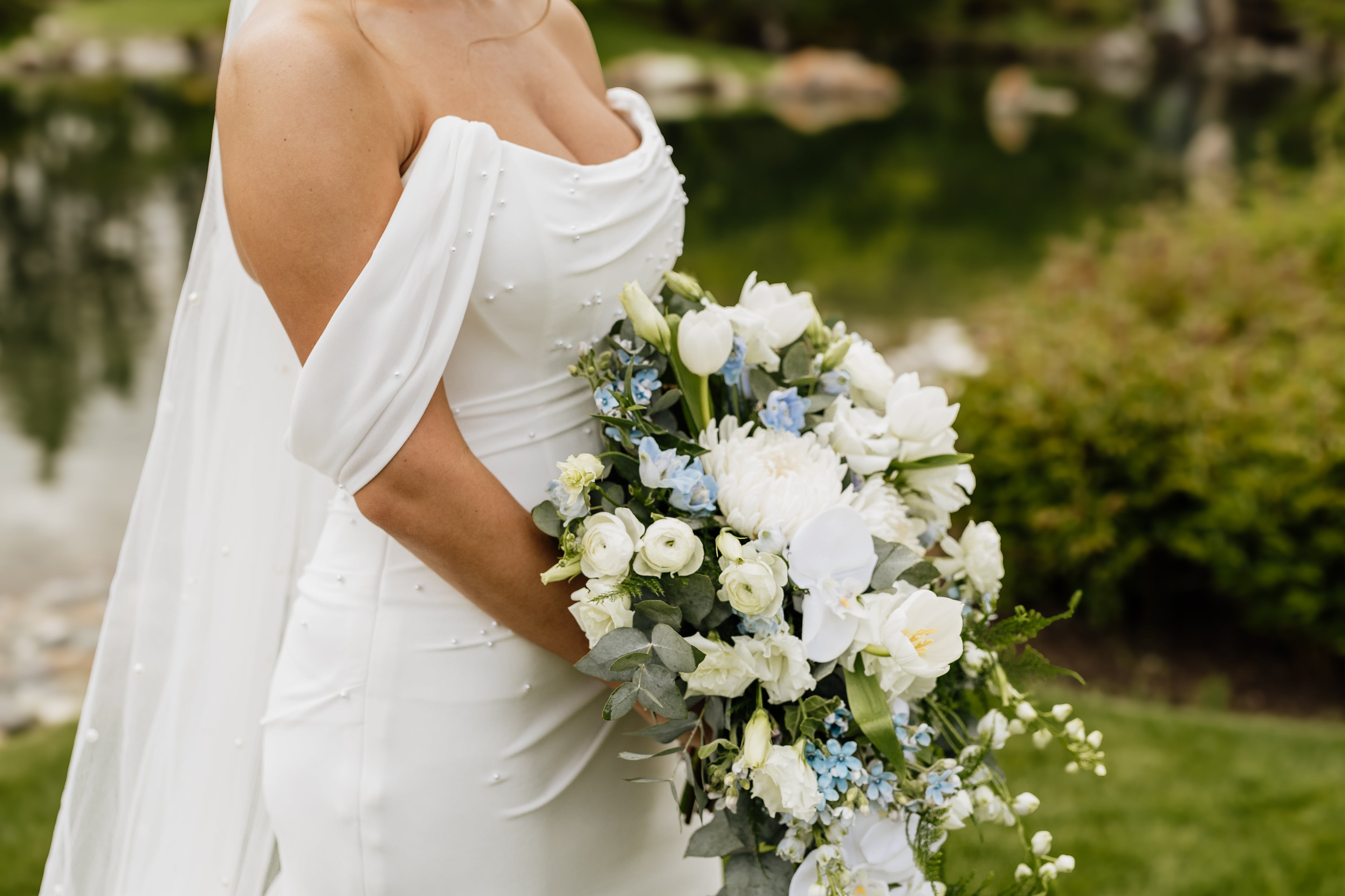 Lethbridge Wedding Flowers bridal bouquet white cascading roses ranunculus delphinium orchids tweedia tulips